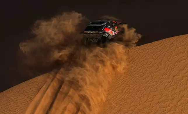 Driver Sebastien Loeb and co-driver Edouard Boulanger compete during the ninth stage of the Dakar Rally between Wadi Ad Dawasir and Bisha, Saudi Arabia, Tuesday, Jan.13, 2026. (AP Photo/Thibault Camus)