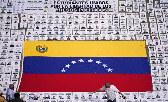 Students lay out photos of people they consider political prisoners at the Central University of Venezuela in Caracas, Venezuela, Tuesday, Jan. 13, 2026. (AP Photo/Matias Delacroix)