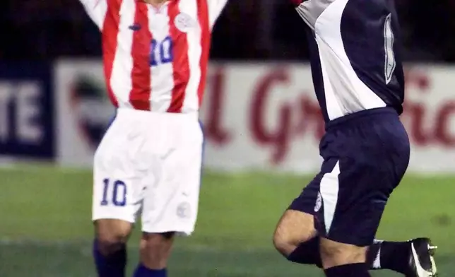 FILE - Jose Luis Chilavert, right, of Paraguay, celebrates after scoring a goal against Colombia in a World Cup qualifying match in Bogota, Columbia, Oct. 7, 2000. (AP Photo/Oswaldo Paez, File)