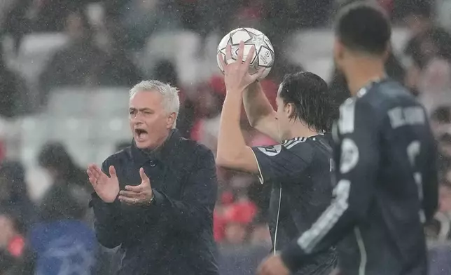 Benfica's head coach Jose Mourinho claps his hands while Real Madrid players look at him during a Champions League opening phase soccer match between Benfica and Real Madrid, in Lisbon, Wednesday, Jan. 28, 2026. (AP Photo/Armando Franca)