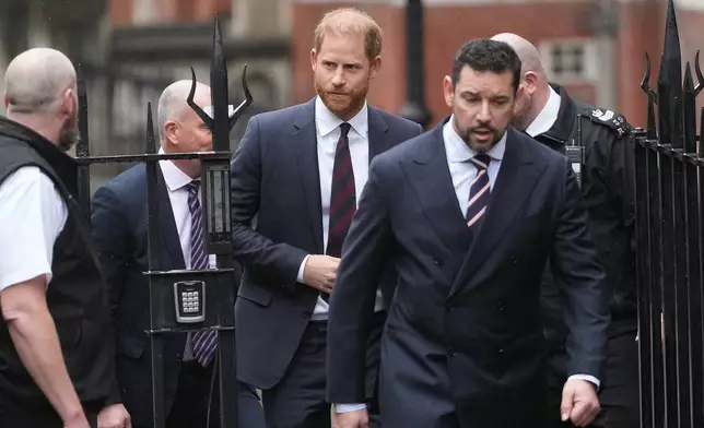 Britain's Prince Harry arrives at London's High Court to lead a group, including Elton John and Elizabeth Hurley, accusing the Daily Mail's publisher of privacy invasion through unlawful tactics in a trial that is part of a wider phone hacking scandal in London, Wednesday, Jan. 21, 2026. (AP Photo/Kirsty Wigglesworth)