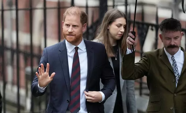 Britain's Prince Harry arrives at London's High Court to lead a group, including Elton John and Elizabeth Hurley, accusing the Daily Mail's publisher of privacy invasion through unlawful tactics in a trial that is part of a wider phone hacking scandal in London, Wednesday, Jan. 21, 2026. (AP Photo/Kirsty Wigglesworth)
