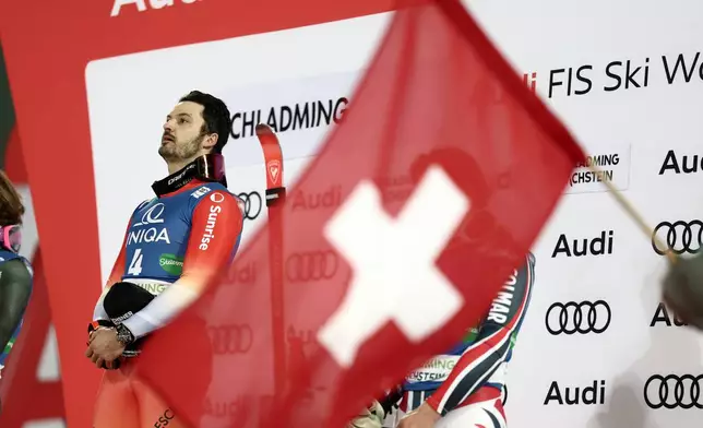 Switzerland's Loic Meillard on the podium after winning an alpine ski, men's World Cup giant slalom in Schladming, Austria, Tuesday, Jan. 27, 2026. (AP Photo/Gabriele Facciotti)