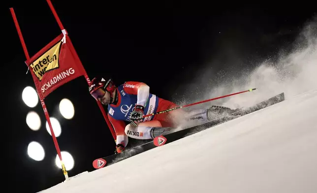 Switzerland's Loic Meillard speeds down the course during an alpine ski, men's World Cup giant slalom in Schladming, Austria, Tuesday, Jan. 27, 2026. (AP Photo/Gabriele Facciotti)