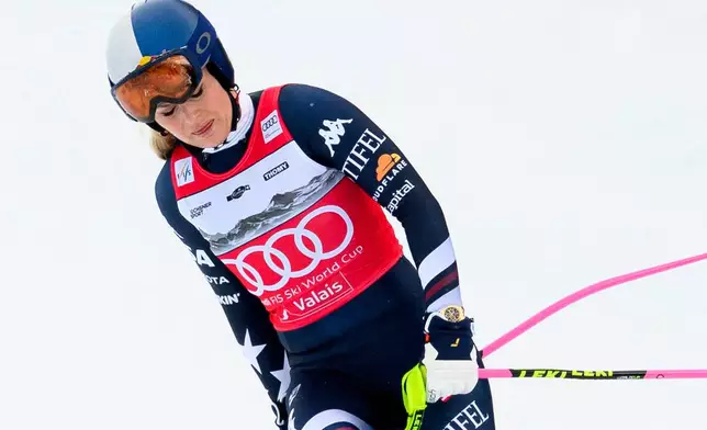United States' Lindsey Vonn approaches the finish area after crashing, during an alpine ski, women's World Cup downhill, in Crans Montana, Switzerland, Friday, Jan. 30, 2026. (Jean-Christophe Bott/Keystone via AP)