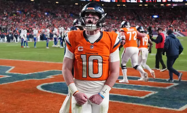 Denver Broncos quarterback Bo Nix celebrates after a touchdown during the second half of an NFL divisional round playoff football game against the Buffalo Bills, Wednesday, Jan. 17, 2024, in Denver. (AP Photo/David Zalubowski)