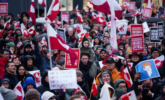 A crowd walks to the US consulate to protest against Trump's policy towards Greenland in Nuuk, Greenland, Saturday, Jan. 17, 2026. (AP Photo/Evgeniy Maloletka)