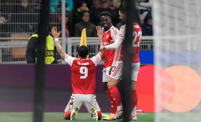 Arsenal's Gabriel Jesus, left, celebrates with his teammates after scoring his side's opening goal during the Champions League opening phase soccer match between Inter Milan and Arsenal in Milan, Italy, Tuesday, Jan. 20, 2026. (AP Photo/Luca Bruno)