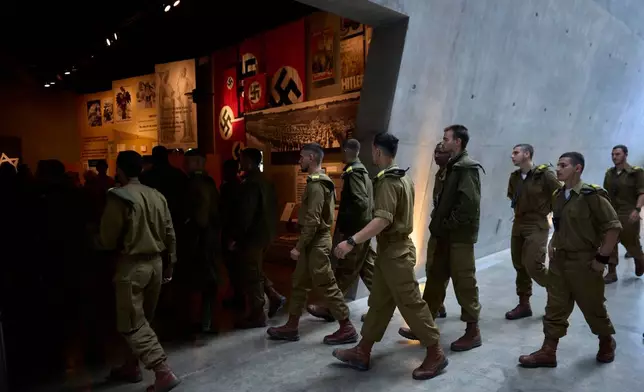 A group of Israeli soldiers looks at exhibits at the Yad Vashem Holocaust memorial in Jerusalem, ahead of the International Holocaust Remembrance Day, Sunday, Jan. 25, 2026. (AP Photo/Ohad Zwigenberg)