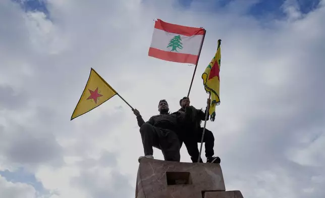 Kurdish citizens wave their group and Lebanese flags during a protest against the Syrian government military operation in Aleppo, in front the United Nations headquarters in Beirut, Lebanon, Saturday, Jan. 10, 2026. (AP Photo/Hussein Malla)
