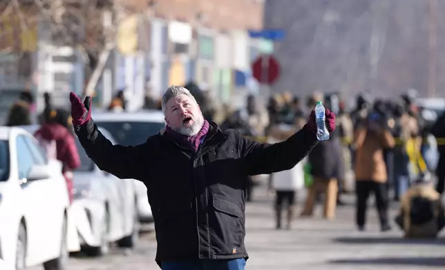 A person reacts to Federal immigration officers after a shooting Saturday, Jan. 24, 2026, in Minneapolis. (AP Photo/Abbie Parr)