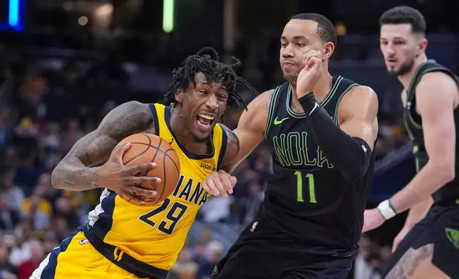 Indiana Pacers guard Quenton Jackson (29) is fouled by New Orleans Pelicans guard Bryce McGowens (11) during the second half of an NBA basketball game in Indianapolis, Friday, Jan. 16, 2026. (AP Photo/Michael Conroy)