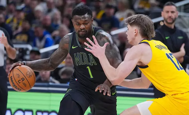 New Orleans Pelicans forward Zion Williamson (1) drives on Indiana Pacers guard Johnny Furphy (12) during the first half of an NBA basketball game in Indianapolis, Friday, Jan. 16, 2026. (AP Photo/Michael Conroy)