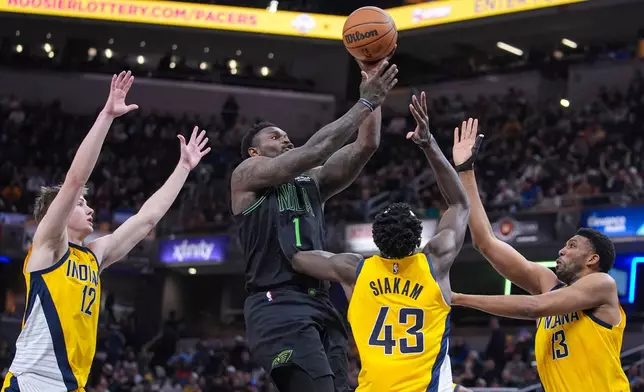 New Orleans Pelicans forward Zion Williamson (1) shoots over Indiana Pacers guard Johnny Furphy (12), forward Pascal Siakam (43) and center Tony Bradley (13) during the first half of an NBA basketball game in Indianapolis, Friday, Jan. 16, 2026. (AP Photo/Michael Conroy)
