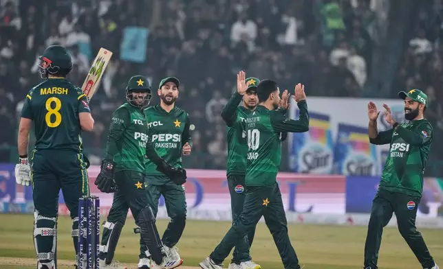 Pakistan's Abrar Ahmed, second right, celebrates with teammates after the dismissal of Australia's Mitchell Marsh, left, during the second T20 cricket match between Pakistan and Australia, in Lahore, Pakistan, Saturday, Jan. 31, 2026. (AP Photo/K.M. Chaudary)