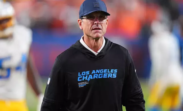 Los Angeles Chargers head coach Jim Harbaugh leaves the field after an NFL football game against the Denver Broncos Sunday, Jan. 4, 2026, in Denver. (AP Photo/David Zalubowski)