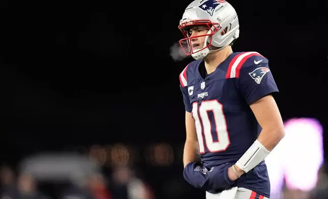 New England Patriots quarterback Drake Maye walks on the sideline during the first half of an NFL football game against the Miami Dolphins in Foxborough, Mass., Sunday, Jan. 4, 2026. (AP Photo/Charles Krupa)