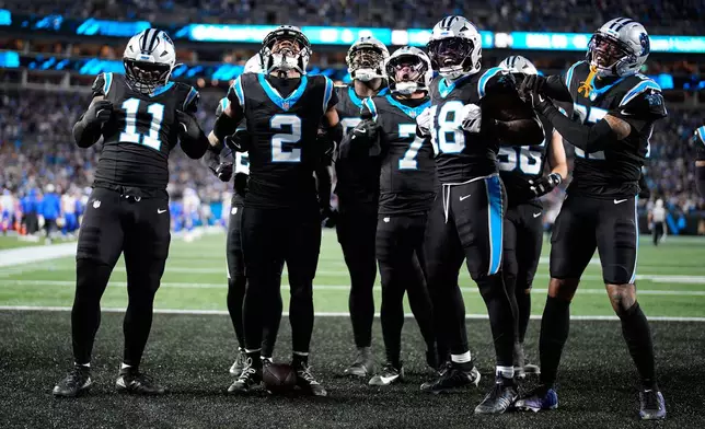 Carolina Panthers cornerback Mike Jackson (2) celebrates with teammates after intercepting a pass by Los Angeles Rams quarterback Matthew Stafford during the second half of an NFL wild-card playoff football game, Saturday, Jan. 10, 2026, in Charlotte, N.C. (AP Photo/Jacob Kupferman)