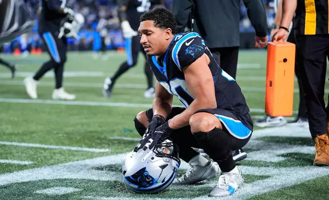 Carolina Panthers running back Chuba Hubbard (30) kneels on the field after a loss to the Los Angeles Rams in an NFL wild-card playoff football game, Saturday, Jan. 10, 2026, in Charlotte, N.C. (AP Photo/Erik Verduzco)