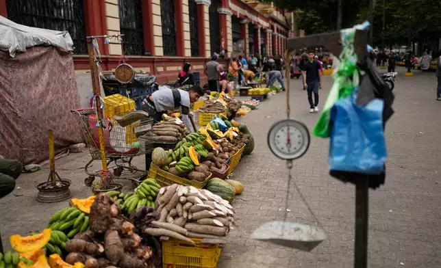 Vendors display vegetables at a street market in Caracas, Venezuela, Thursday, Jan. 8, 2026. (AP Photo/Matias Delacroix)