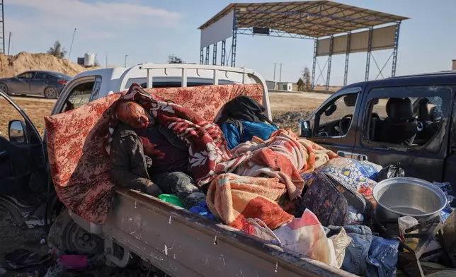 The bodies of civilians, believed to have been caught in crossfire between Syrian government forces and retreating Syrian Democratic Forces (SDF) troops, lies in the back of a pickup truck along a road between government-controlled Raqqa and SDF-controlled Hassakeh in northeastern Syria, Tuesday, Jan. 20, 2026. (AP Photo/Omar Albam)