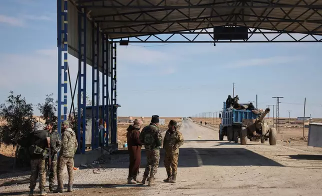 Syrian government troops are seen at an abandoned checkpoint between government-controlled Raqqa and Hassakeh, controlled by the Syrian Democratic Forces (SDF), in northeastern Syria, Jan. 20, 2026. (AP Photo/Omar Albam)