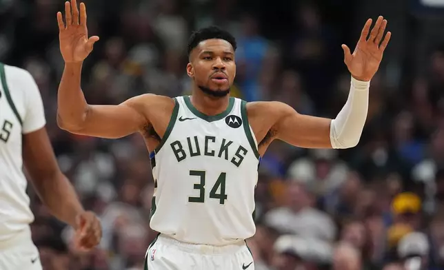 Milwaukee Bucks forward Giannis Antetokounmpo looks for direction from the bench in the first half of an NBA basketball game against the Denver Nuggets, Sunday, Jan. 11, 2026, in Denver. (AP Photo/David Zalubowski)