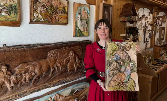 Jasmine Feuchter poses for a photo in a traditional craft shop in San Vigilio di Marebbe, northern Italy, Monday, Jan. 26, 2026. (AP Photo/Nicole Winfield)