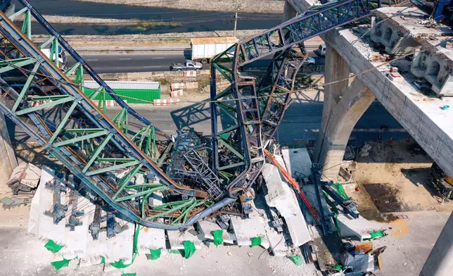 A construction crane that collapsed on the Rama 2 Road elevated expressway in Samut Sakhon province, Thailand on Thursday, Jan. 15, 2026. (AP Photo/Arnun Chonmahatrakool)