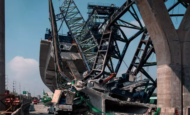 A construction crane that collapsed on the Rama 2 Road elevated expressway in Samut Sakhon province, Thailand on Thursday, Jan. 15, 2026. (AP Photo/Arnun Chonmahatrakool)