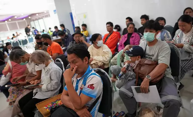 Relatives of victims and others wait at a hospital, a day after a construction crane fell into a passenger train in Nakhon Ratchasima province, Thailand, Thursday, Jan. 15, 2026. (AP Photo/Sakchai Lalit)
