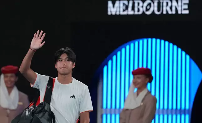 Learner Tien of the U.S. waves as he leaves the court following his quarterfinal loss to Alexander Zverev of Germany at the Australian Open tennis championship in Melbourne, Australia, Tuesday, Jan. 27, 2026. (AP Photo/Asanka Brendon Ratnayake)