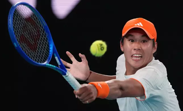 Learner Tien of the U.S. plays a backhand return to Alexander Zverev of Germany during their quarterfinal match at the Australian Open tennis championship in Melbourne, Australia, Tuesday, Jan. 27, 2026. (AP Photo/Dar Yasin)