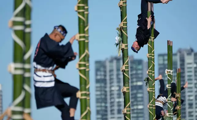 Members of a traditional firefighting preservation group perform ladder stunts during the annual New Year's Fire Brigade Review Tuesday, Jan. 6, 2026, in Tokyo. (AP Photo/Eugene Hoshiko)