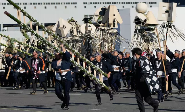Members of a traditional firefighting preservation group dish to take positions to perform during the annual New Year's Fire Brigade Review Tuesday, Jan. 6, 2026, in Tokyo. (AP Photo/Eugene Hoshiko)