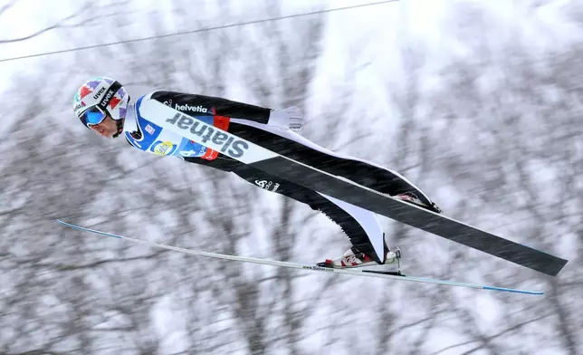 Simon Ammann of Switzerland in action during the men's team flying trial round at the Nordic skiing/ski jumping World Championships in Oberstdorf, Germany, Sunday Jan. 25, 2026. (Karl-Josef Hildenbrand/dpa via AP)