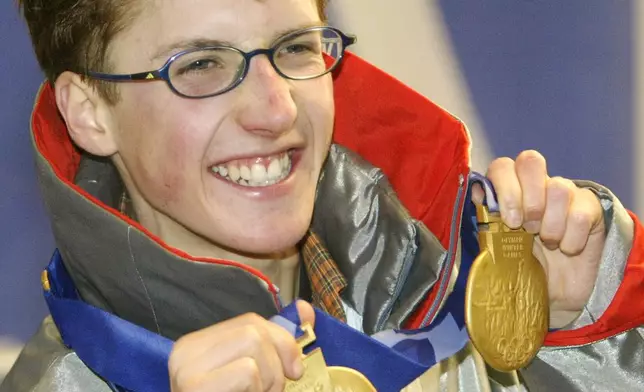 FILE - Simon Ammann of Switzerland shows off his two Olympic gold medals after receiving his second gold medal for his performance in the K120 ski jump in Salt Lake City, on Feb. 13, 2002. (AP Photo/Tom Hanson, CP, FILE)