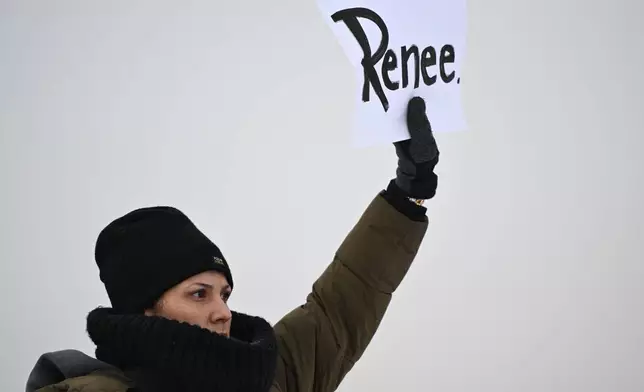 A protesters holds up a sign reading "Renee", the woman shot and killed by a U.S. Immigration and Customs Enforcement officer in Minneapolis on Wednesday, outside the Bishop Henry Whipple Federal Building, Thursday, Jan. 8, 2026, in Minneapolis, Minn. (AP Photo/Tom Baker)
