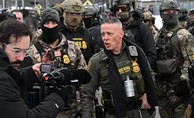 U.S. Border Patrol Cmdr. Gregory Bovino arrives as protesters gather outside the Bishop Henry Whipple Federal Building, Thursday, Jan. 8, 2026, in Minneapolis, Minn. (AP Photo/Tom Baker)