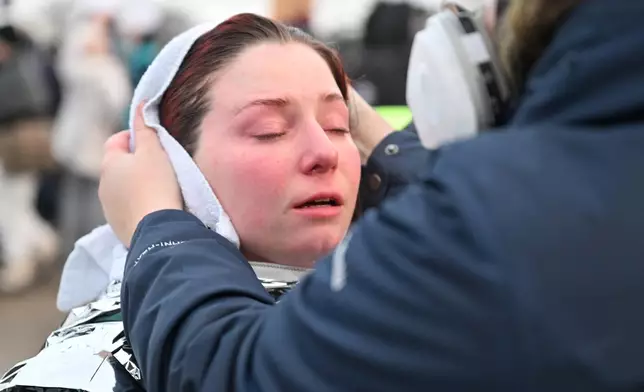 A protester revives aid after confronting law enforcement outside the Bishop Henry Whipple Federal Building, Thursday, Jan. 8, 2026, in Minneapolis, Minn. (AP Photo/Tom Baker)