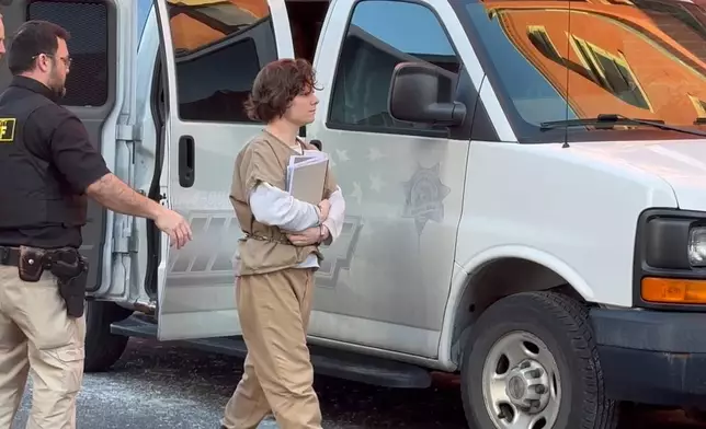 In this image from video, Michelle Zajko, who is associated with a cultlike group known as Zizians that is linked to several deaths across the U.S., is escorted into court for a pretrial hearing on trespassing, gun and drug charges in Cumberland, Md., Friday, Jan. 16, 2026. (AP Photo/Mark Scolforo)