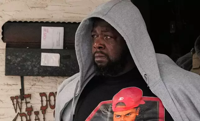 ADDS IDENTIFICATION: Garrison Gibson becomes emotional as he is arrested by federal immigration officers Sunday, Jan. 11, 2026, in Minneapolis. (AP Photo/John Locher)