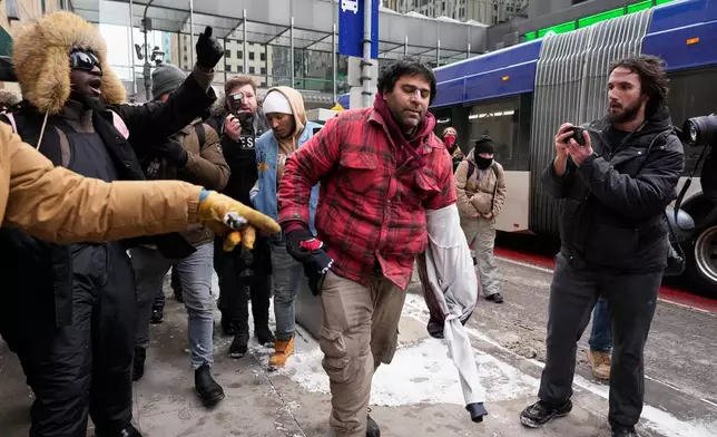 A Jake Lang supporter clashes with counterprotesters the March Against Minnesota Fraud rally near Minneapolis City Hall, Saturday, Jan. 17, 2026, in Minneapolis. (AP Photo/Yuki Iwamura)