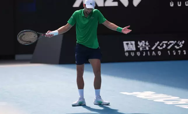 Novak Djokovic of Serbia reacts during his quarterfinal match against Lorenzo Musetti of Italy at the Australian Open tennis championship in Melbourne, Australia, Wednesday, Jan. 28, 2026. (AP Photo/Dita Alangkara)