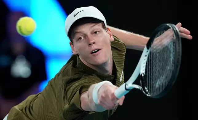 Jannik Sinner of Italy plays a backhand return to Ben Shelton of the U.S. during their quarterfinal match at the Australian Open tennis championship in Melbourne, Australia, Wednesday, Jan. 28, 2026. (AP Photo/Aaron Favila)