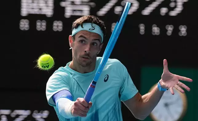 Lorenzo Musetti of Italy plays a backhand return to Novak Djokovic of Serbia during their quarterfinal match at the Australian Open tennis championship in Melbourne, Australia, Wednesday, Jan. 28, 2026. (AP Photo/Dita Alangkara)