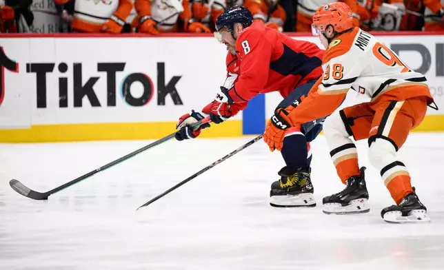 Washington Capitals left wing Alex Ovechkin (8) skates with the puck against Anaheim Ducks defenseman Pavel Mintyukov (98) during the first period of an NHL hockey game, Monday, Jan. 5, 2026, in Washington. (AP Photo/Nick Wass)