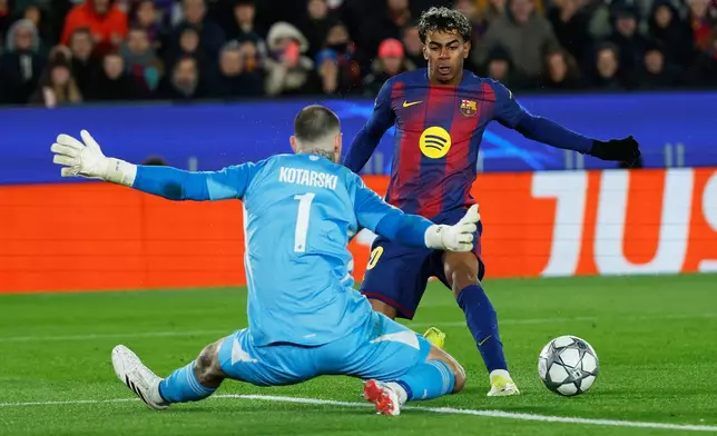 Barcelona's Lamine Yamal fights for the ball against Copenhagen's goalkeeper Dominik Kotarski during the Champions League opening phase soccer match between Barcelona and Copenhagen in Barcelona, Spain, on Wednesday, Jan. 28, 2026. (AP Photo/Joan Monfort)