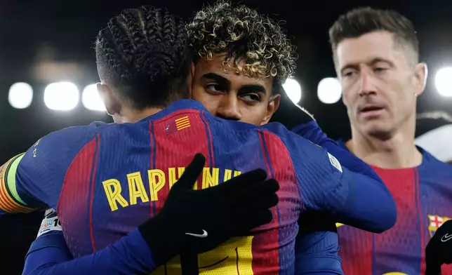 Barcelona's Raphinha celebrates with Lamine Yamal his side's third goal from a penalty kick during the Champions League opening phase soccer match between Barcelona and Copenhagen in Barcelona, Spain, on Wednesday, Jan. 28, 2026. (AP Photo/Joan Monfort)