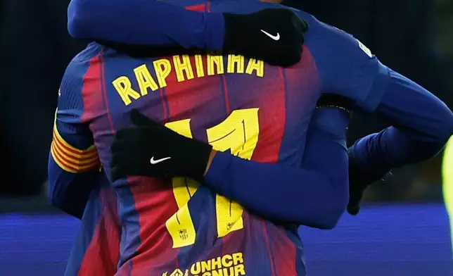Barcelona's Lamine Yamal celebrates with Raphinha his side's second goal during the Champions League opening phase soccer match between Barcelona and Copenhagen in Barcelona, Spain, on Wednesday, Jan. 28, 2026. (AP Photo/Joan Monfort)